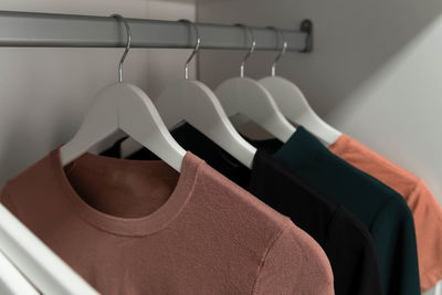 Collection of female clothes hanging on rack. hangers with clothes.