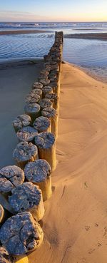 Stones on beach against sky