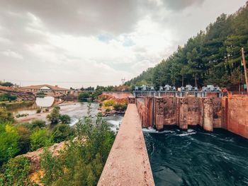 Bridge over river against sky