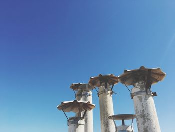 Low angle view of statue against clear blue sky