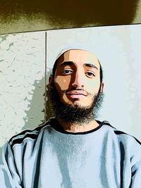 Close-up portrait of young man standing against wall