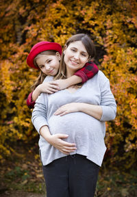 Portrait of smiling young woman with autumn leaves