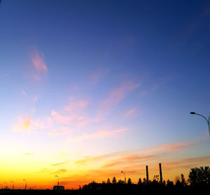 Silhouette of buildings against sky during sunset