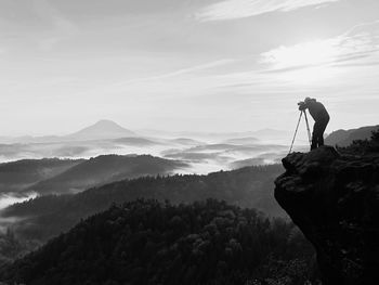 Nature photographer takes photos. dreamy foggy landscape, spring misty sunrise in a beautiful valley