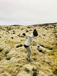 Side view of woman jumping outdoors