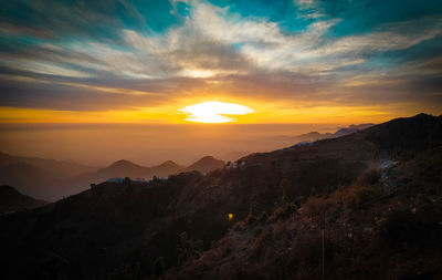 Scenic view of mountains against sky during sunset