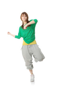 Portrait of young woman standing against white background