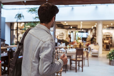 Rear view of man standing at restaurant