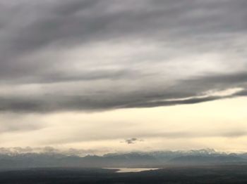 Scenic view of mountains against cloudy sky