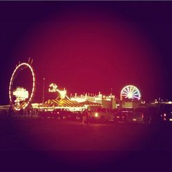 Illuminated ferris wheel at night