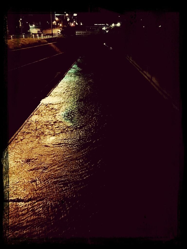 night, illuminated, transfer print, architecture, built structure, auto post production filter, building exterior, high angle view, the way forward, road, city, street, dark, outdoors, transportation, no people, diminishing perspective, light - natural phenomenon, shadow, incidental people