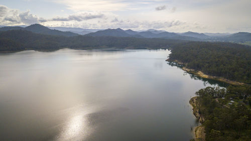 Scenic view of river and mountains against sky