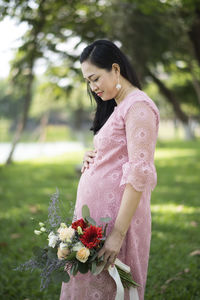 Side view of woman standing on field