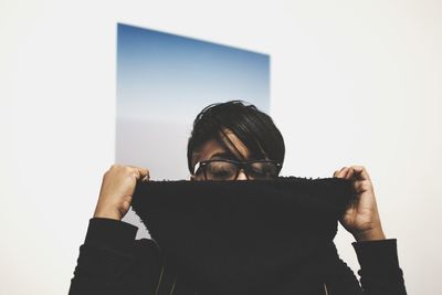 Midsection of man with camera against sky