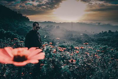 Midsection of man against sky during sunset