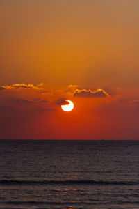 Scenic view of sea against orange sky