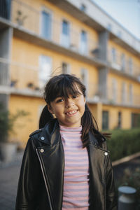 Portrait of happy smiling girl in leather jacket