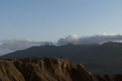 Woman on old abandoned mine view the mountains with clouds background in murcia, spain