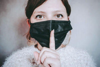 Portrait of girl holding snow covered face