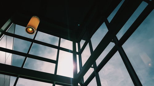 Low angle view of illuminated pendant light hanging from ceiling