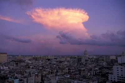 High angle view of townscape against cloudy sky at sunset