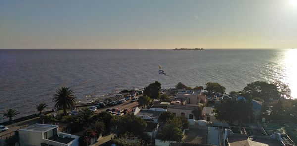 High angle view of buildings by sea against clear sky