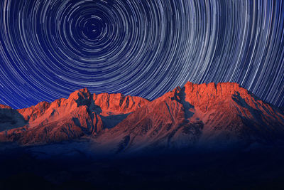 Tilt image of mountain against sky at night