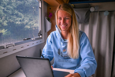 Portrait of young woman using laptop