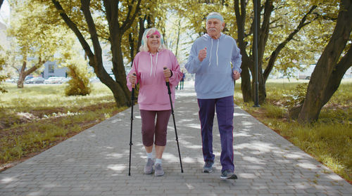 Rear view of couple walking on footpath