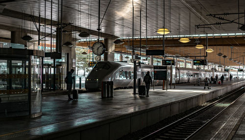 People waiting at railroad station platform