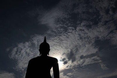 Low angle view of silhouette statue against sky