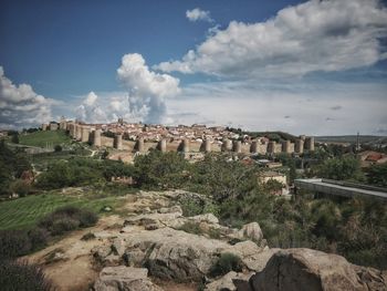 Buildings against cloudy sky