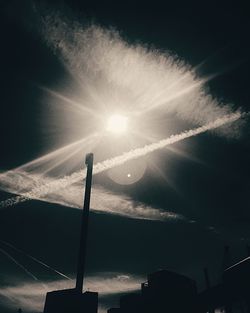 Low angle view of vapor trails against sky