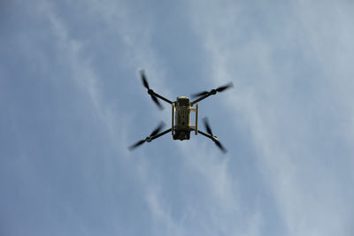 Drone in sky. quadro copter flies in air. surveillance from height. four propellers. 