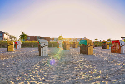 Scenic view of beach against clear sky during sunset