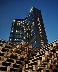 Low angle view of modern buildings against clear blue sky