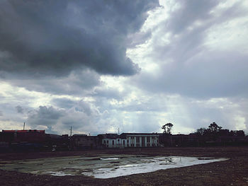 Buildings by street against sky