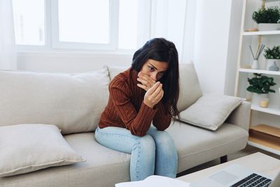 Young woman using laptop at home