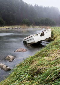 Boat on lake against trees