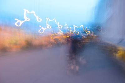 Blurred motion of man on illuminated city street