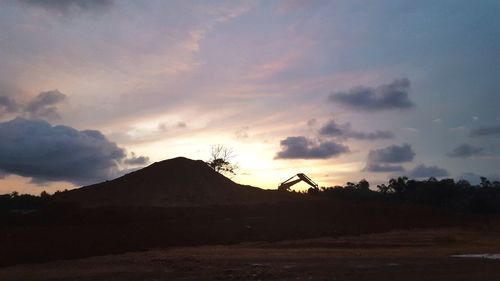 Silhouette landscape against sky during sunset