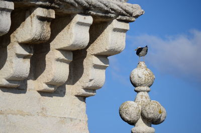 Low angle view of statue against sky