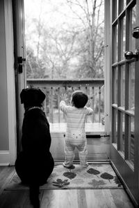 Rear view of children playing in corridor