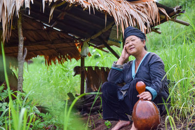 Full length of man sitting on field