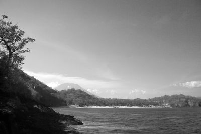 Scenic view of sea and mountains against sky