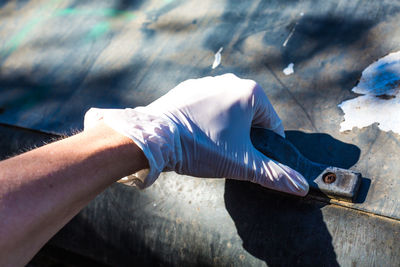 High angle view of woman hand holding wood