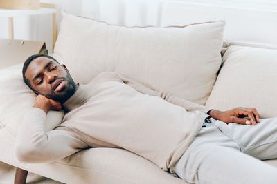 Young woman sleeping on bed at home