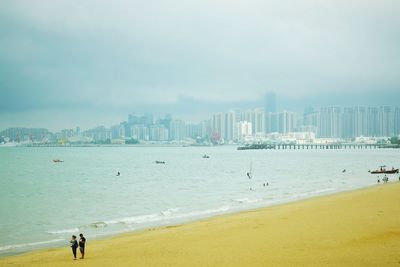 View of beach with city in background