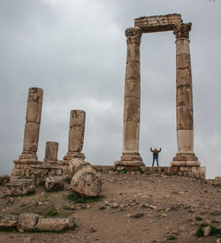 Low angle view of historical building against cloudy sky