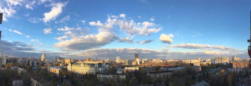 Panoramic view of cityscape against blue sky